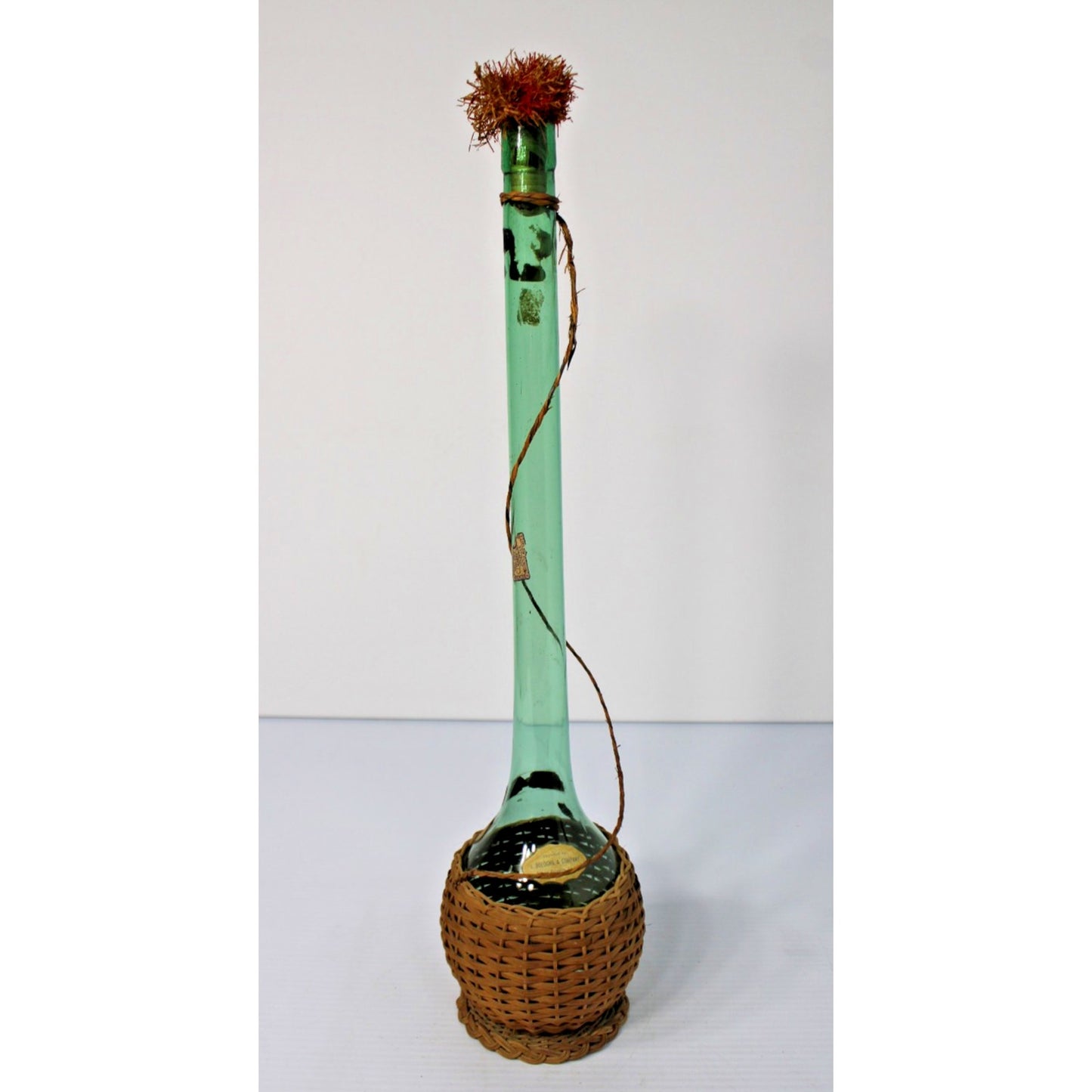 Vintage 21"H Green Glass Demijohn Carafe in Raffia, New Orleans Import Label